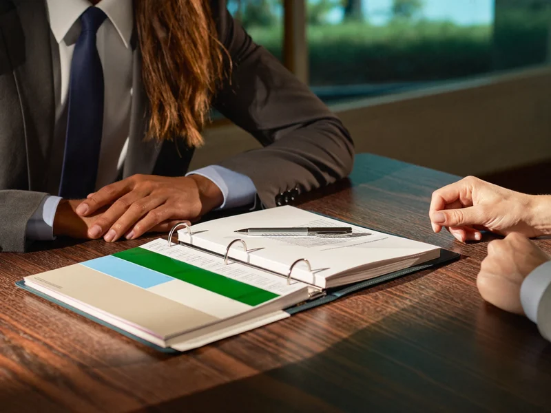 Illustration of an appeal binder with blank tabs reviewed beside a client